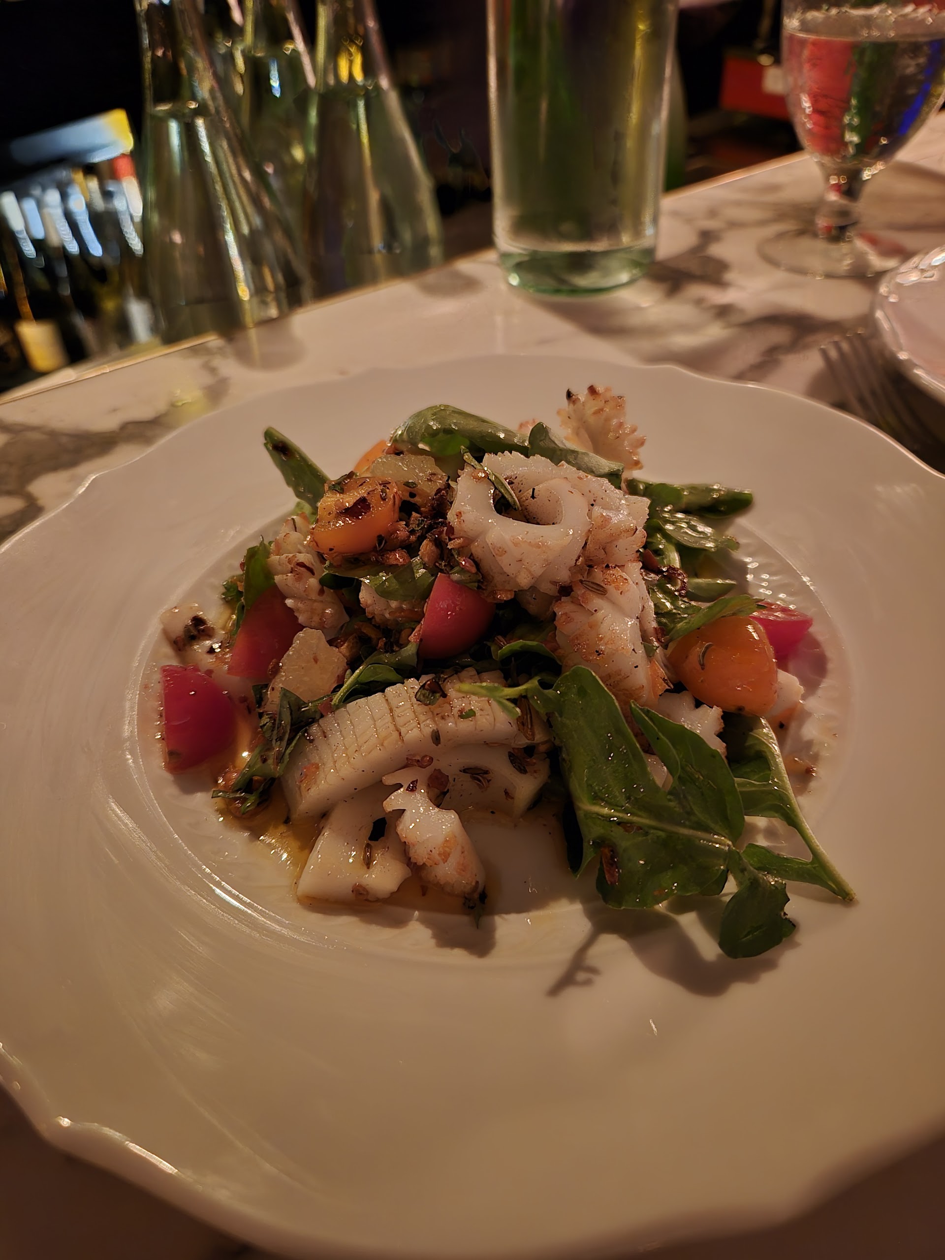 Calamari and greens on marble under the Grotto lights